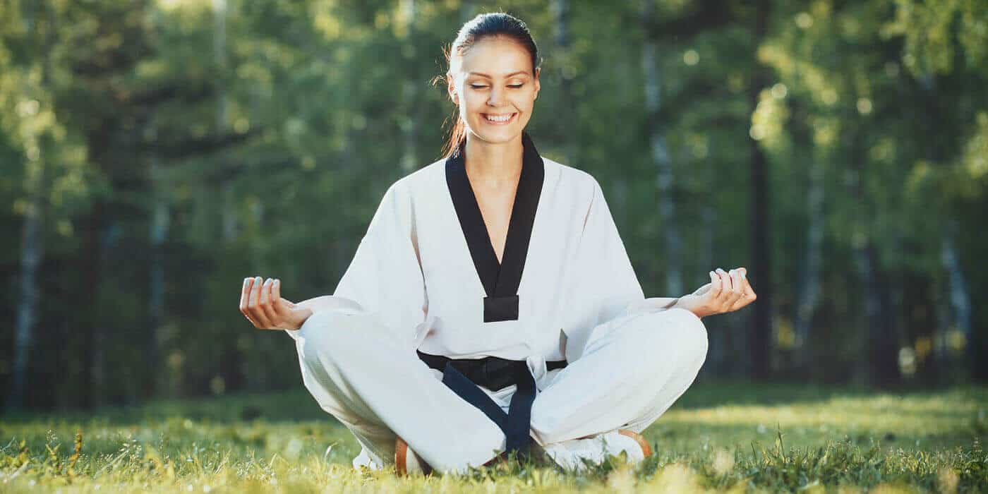 Martial Arts Lessons for Adults in Mobile AL - Happy Woman Meditated Sitting Background